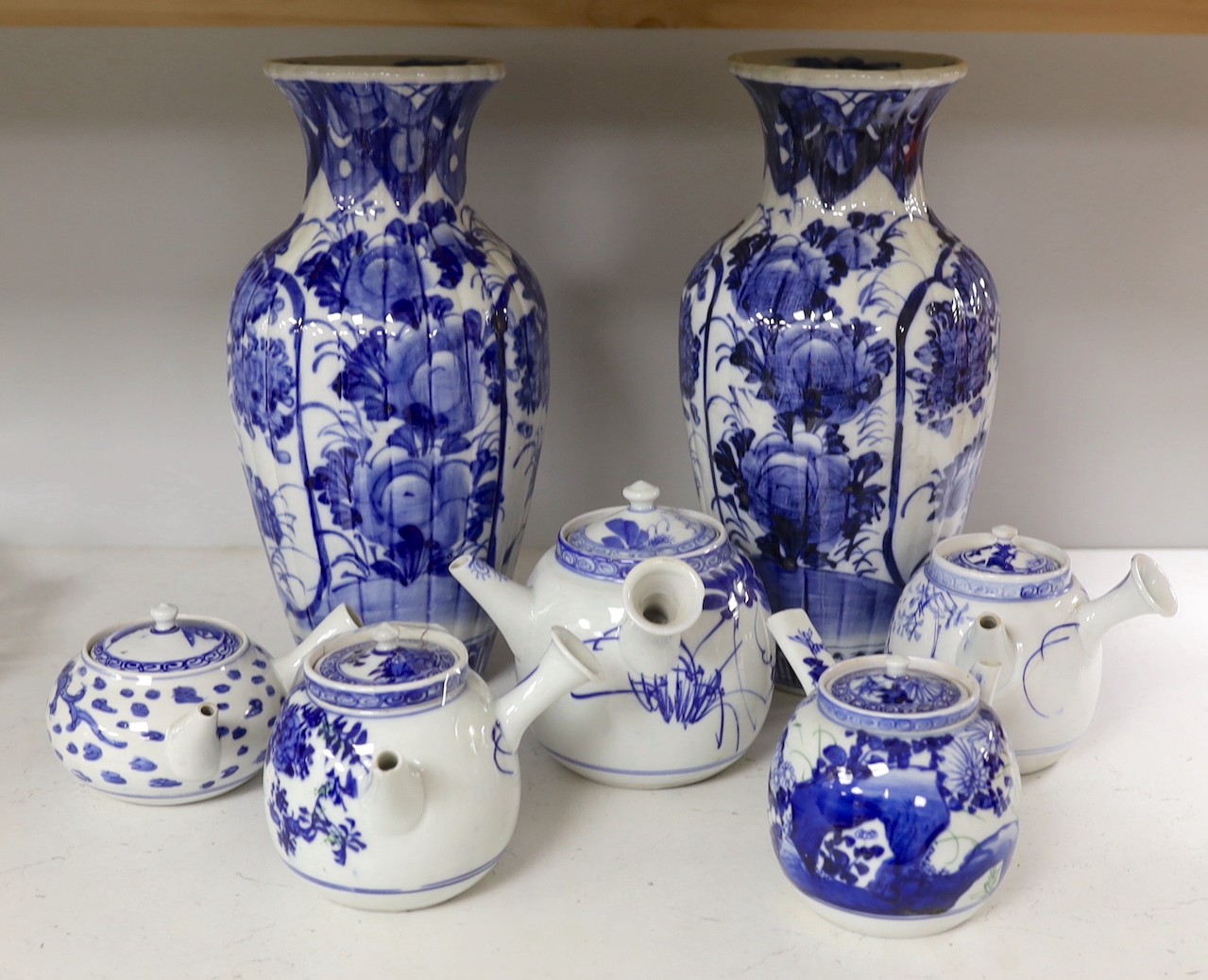 A pair of Japanese blue and white vases and various Japanese blue and white porcelain teapots and covers, tallest 30cm